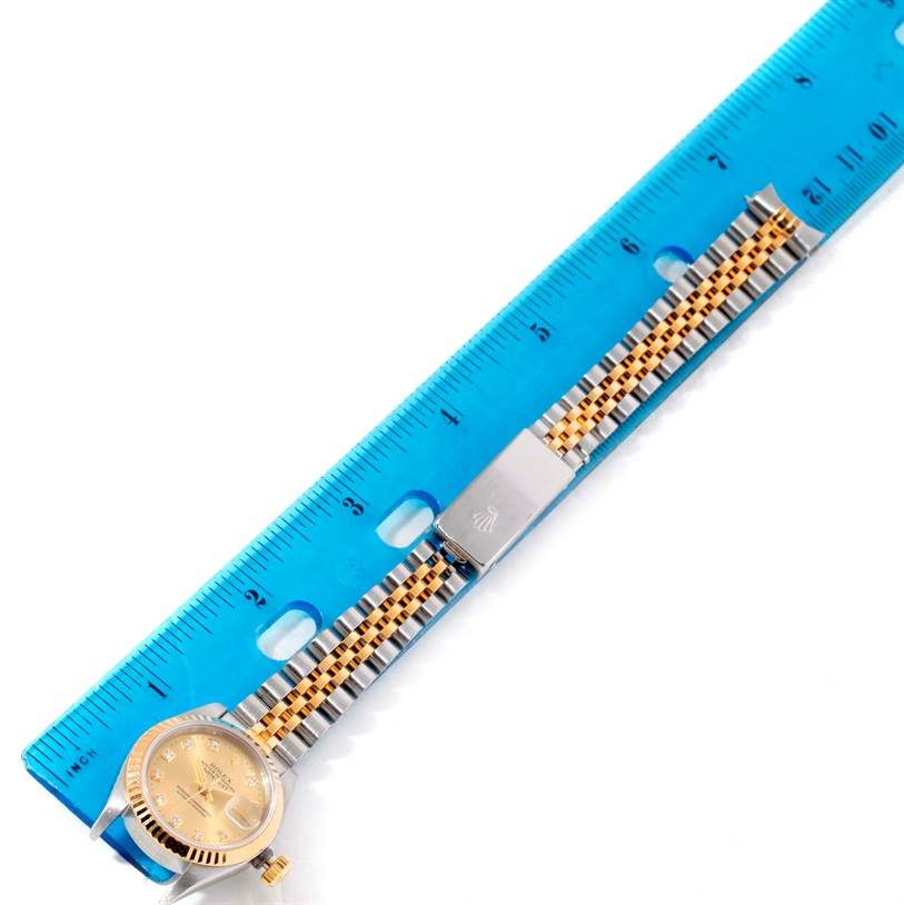 The image shows a Rolex Datejust 69173 Women's Stainless Steel Champagne Dial 69173 Women's Stainless Steel Champagne Dial watch from an overhead angle with a blue ruler for scale.