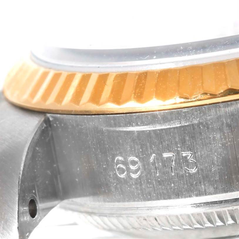 This image shows a close-up of the model number and fluted bezel of a Rolex Datejust 69173 Women's Stainless Steel White Dial 69173 Women's Stainless Steel White Dial watch.
