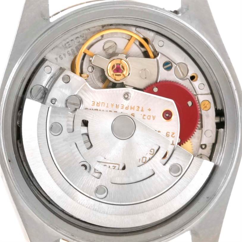 The image shows a close-up view of the movement inside a Rolex Datejust 69173 Women's Stainless Steel White Dial 69173 Women's Stainless Steel White Dial watch, displaying the intricate inner mechanics.