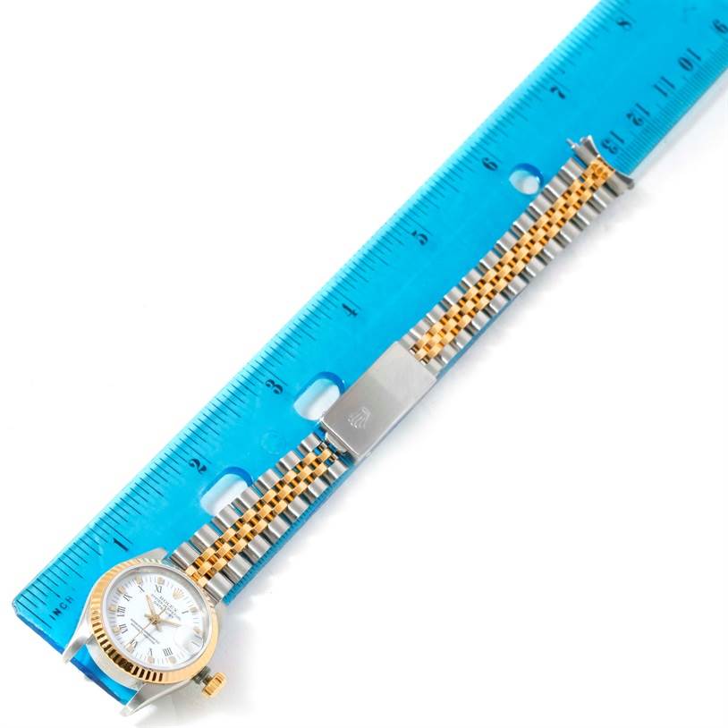 The image shows a Rolex Datejust 69173 Women's Stainless Steel White Dial 69173 Women's Stainless Steel White Dial watch placed alongside a ruler, highlighting the watch face, band, and clasp.