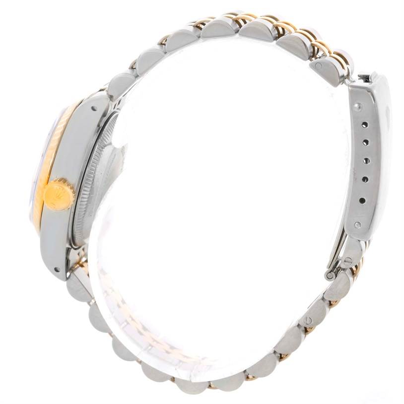 The image shows a side view of a Rolex Datejust 69173 Women's Stainless Steel White Dial 69173 Women's Stainless Steel White Dial watch, highlighting its clasp, case, and partially visible golden crown.