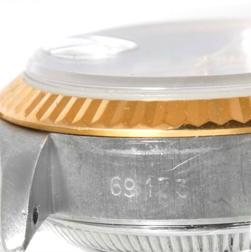 The image shows a close-up side view of the Rolex Datejust 69173 Women
s Stainless Steel White Dial 69173 Women
s Stainless Steel White Dial watch, focusing on the bezel, crystal, and case.