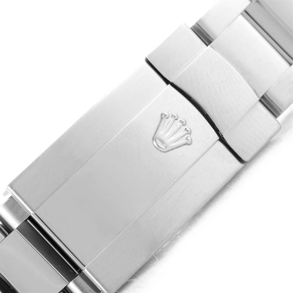 This image shows a close-up of the clasp of a Rolex Datejust 116244 Men's Stainless Steel Brown Dial 116244 Men's Stainless Steel Brown Dial watch, featuring the brand's logo.