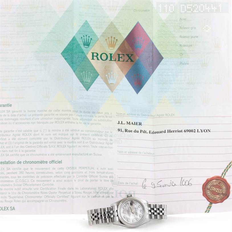 The Rolex Datejust 179174 Women's Stainless Steel Mother of Pearl Dial 179174 Women's Stainless Steel Mother of Pearl Dial watch is shown from a front angle alongside its warranty document.