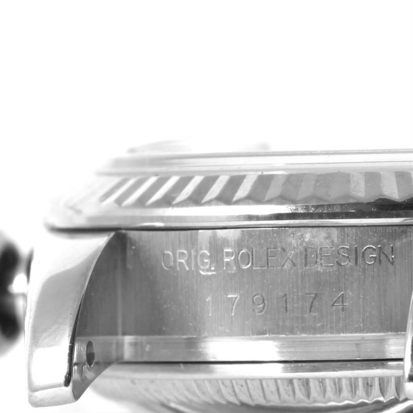 The image shows a close-up side angle of the Rolex Datejust 179174 Women's Stainless Steel Mother of Pearl Dial 179174 Women's Stainless Steel Mother of Pearl Dial model, highlighting the bezel, lugs, and engraved details.