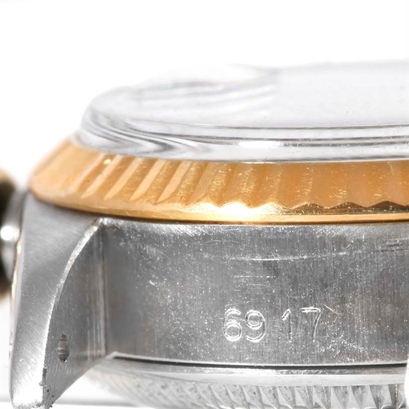 This image shows a close-up side view of the Rolex Datejust 6917 Women's Stainless Steel Champagne Dial 6917 Women's Stainless Steel Champagne Dial model, highlighting part of the case, bezel, and crystal.