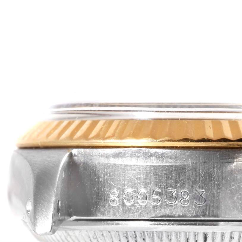 The image shows a close-up side view of a Rolex Datejust 6917 Women's Stainless Steel Champagne Dial 6917 Women's Stainless Steel Champagne Dial watch, highlighting its bezel and serial number.