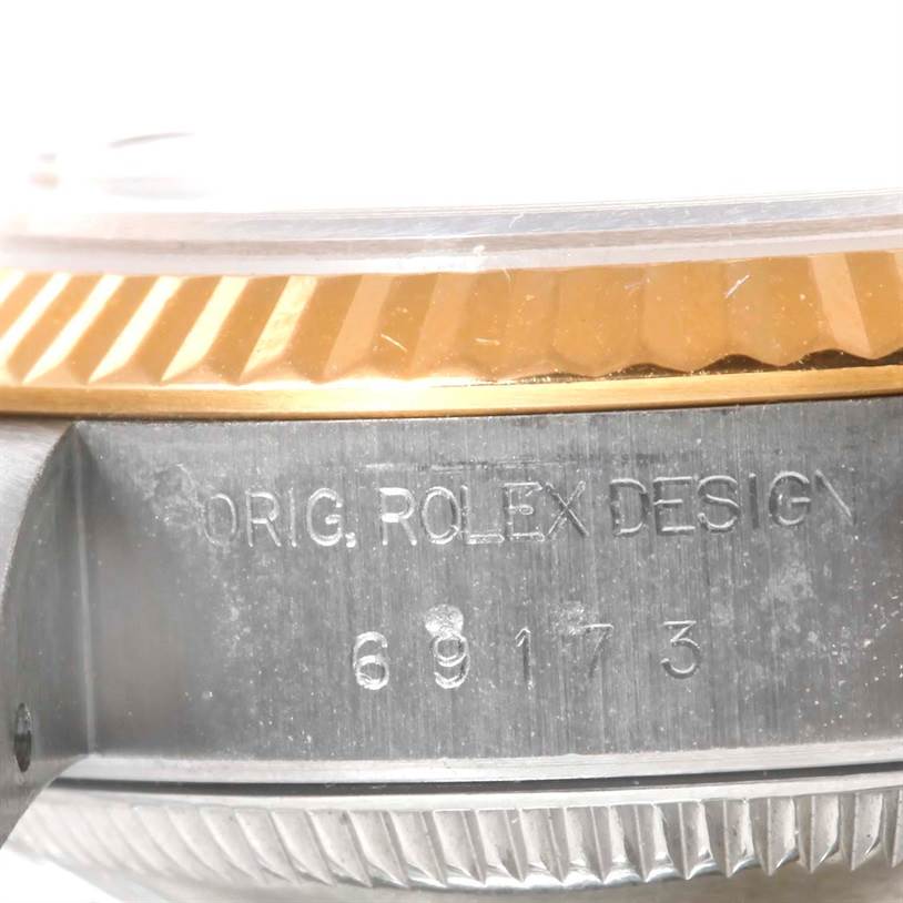 This close-up image shows the side view of a Rolex Datejust 69173 Women
s Stainless Steel Black Dial 69173 Women
s Stainless Steel Black Dial watch, focusing on the bezel and engraved model number.