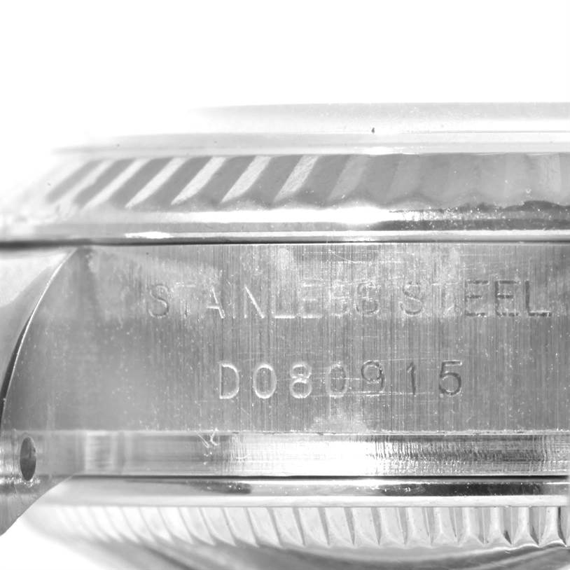 The image shows a close-up of the stainless steel side of a Rolex Datejust 179174 Women
s Stainless Steel Silver Dial 179174 Women
s Stainless Steel Silver Dial watch, including the serial engraving.