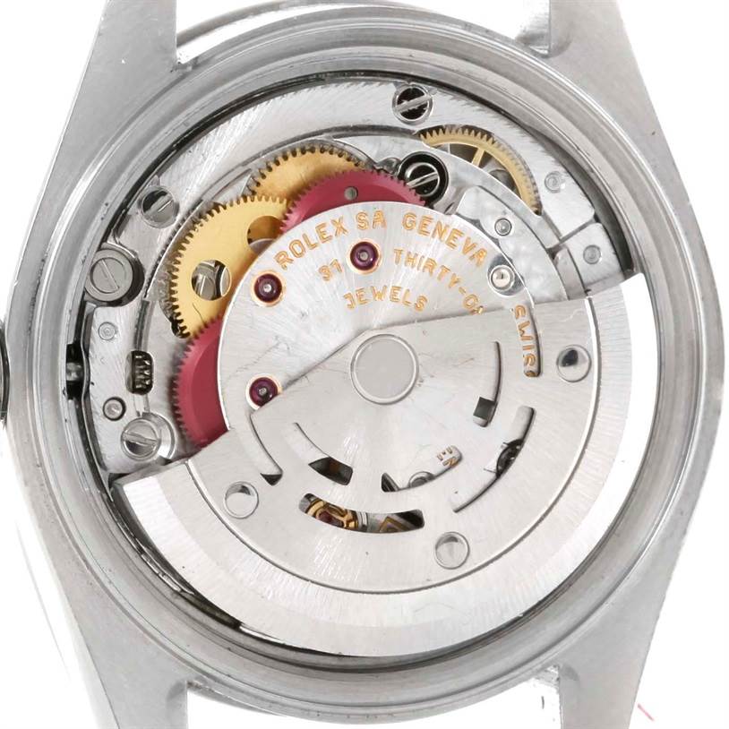 The image shows the movement mechanism of a Rolex Datejust 79174 Women
s Stainless Steel Silver Dial 79174 Women
s Stainless Steel Silver Dial watch from a rear view angle with visible gears and text.