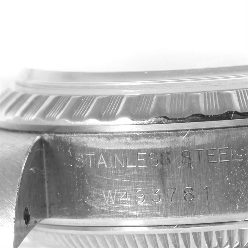 This close-up image shows the side of a Rolex Datejust 69240 Women's Stainless Steel Grey Dial 69240 Women's Stainless Steel Grey Dial watch, highlighting the case back and part of the watch's bezel with its serial number.
