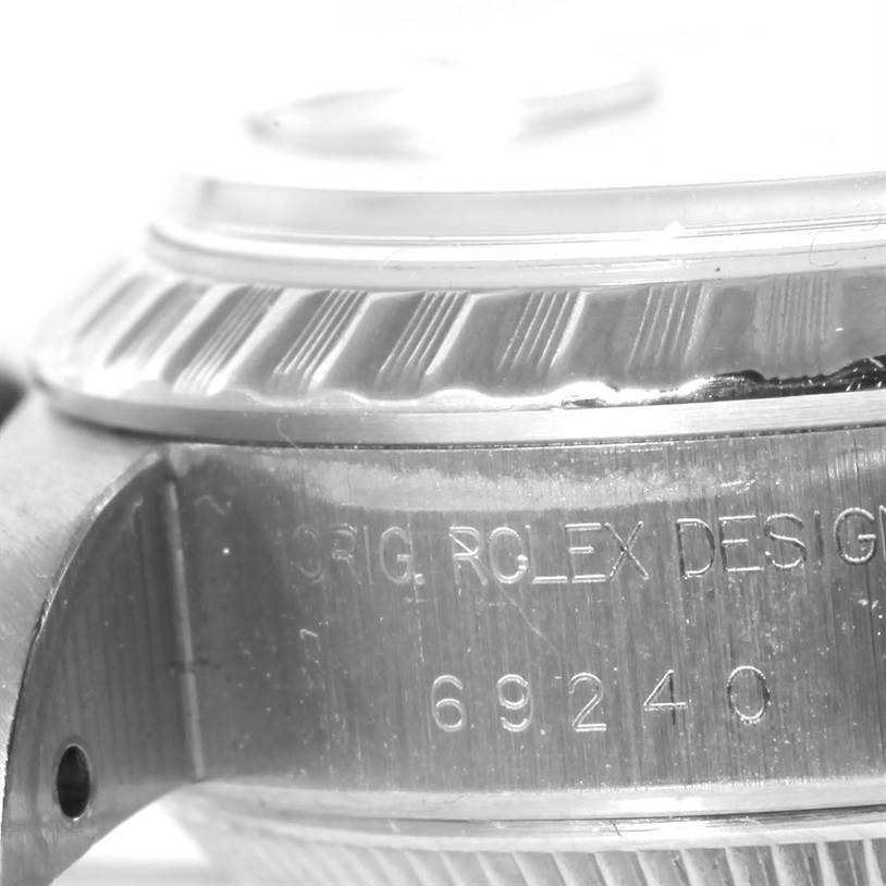 This close-up shot shows the case and bezel with engravings of a Rolex Datejust 69240 Women's Stainless Steel Grey Dial 69240 Women's Stainless Steel Grey Dial watch.