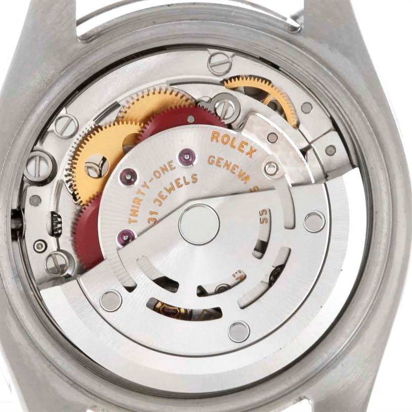 The image shows the intricate internal movement of a Rolex Datejust 179174 Women's Stainless Steel White Dial 179174 Women's Stainless Steel White Dial watch, highlighting its gears and mechanisms from a rear angle.