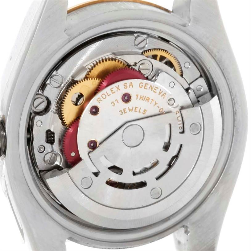 The image shows the movement mechanism of a Rolex Datejust 179173 Women's Steel and Gold (two tone) White Dial 179173 Women's Steel and Gold (two tone) White Dial watch from the back view, highlighting the gears and jewels.
