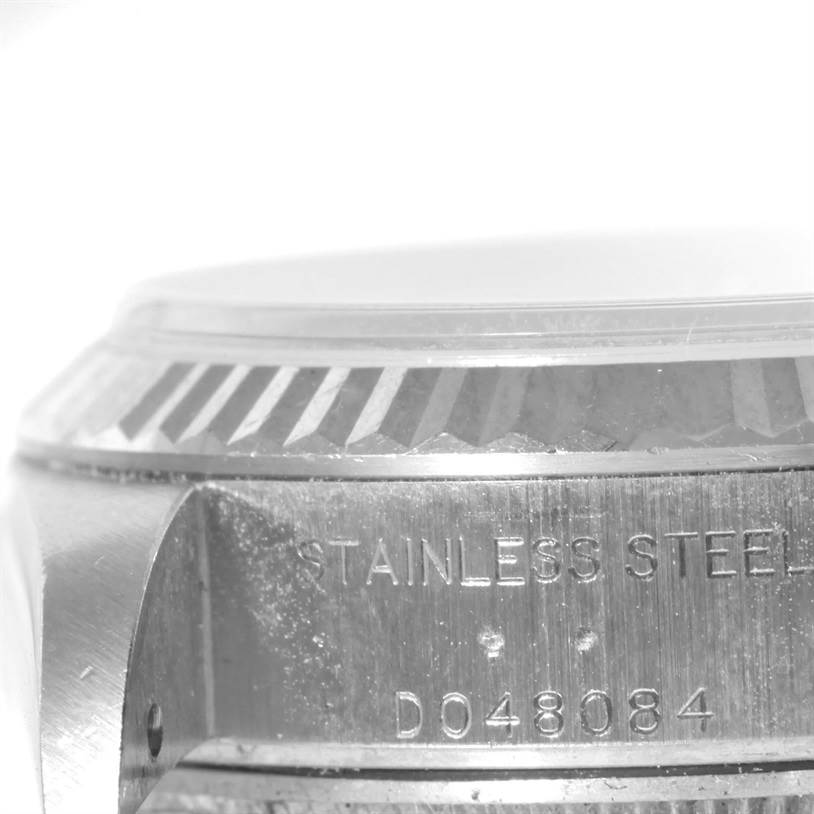 The image shows a close-up of the side of a Rolex Datejust 79174 Women's Stainless Steel Mother of Pearl Dial 79174 Women's Stainless Steel Mother of Pearl Dial watch, focusing on the bezel and case with visible engravings.