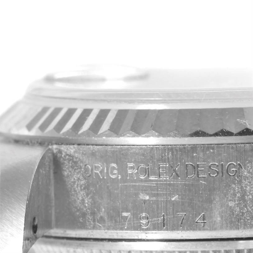 This image shows a close-up side angle of a Rolex Datejust 79174 Women's Stainless Steel Mother of Pearl Dial 79174 Women's Stainless Steel Mother of Pearl Dial watch, highlighting part of its case and bezel with the design number engraved.