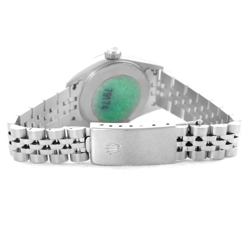 The image shows the back of a Rolex Datejust 79174 Women's Stainless Steel Mother of Pearl Dial 79174 Women's Stainless Steel Mother of Pearl Dial watch, focusing on the caseback and the clasp of the metal bracelet.