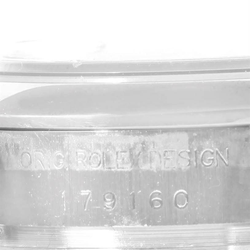 This image shows a close-up of the side of a Rolex Datejust 179160 Women's Stainless Steel White Dial 179160 Women's Stainless Steel White Dial watch case, displaying the serial number and "ORG ROLEX DESIGN" engraving.