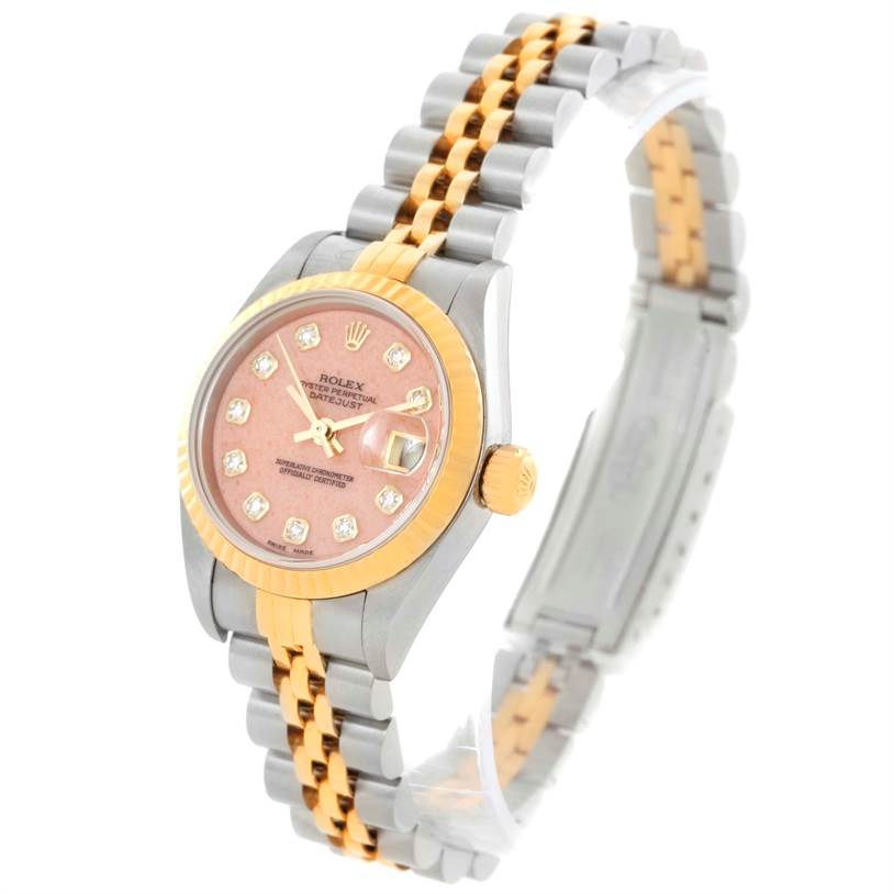 The Rolex Datejust 79163 Women's Steel and Gold (two tone) Pink Dial 79163 Women's Steel and Gold (two tone) Pink Dial watch is shown at an angled view highlighting the pink dial, gold bezel, and two-tone bracelet.