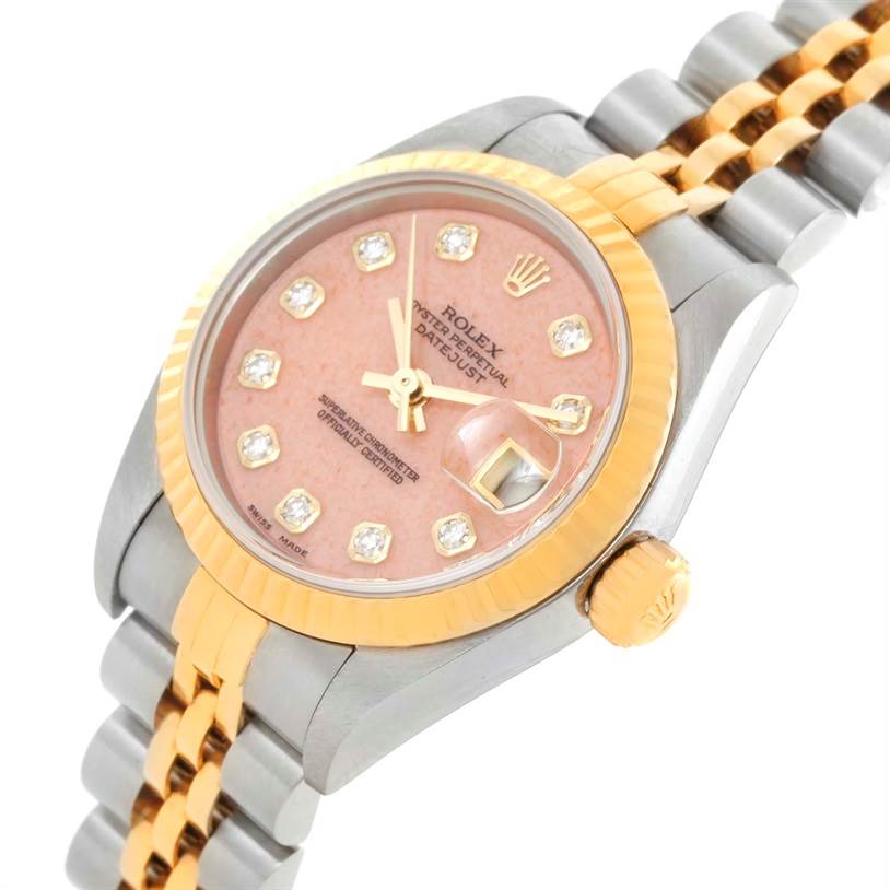 This is a close-up angled view of a Rolex Datejust 79163 Women's Steel and Gold (two tone) Pink Dial 79163 Women's Steel and Gold (two tone) Pink Dial watch featuring its dial, bezel, case, crown, and part of the bracelet.