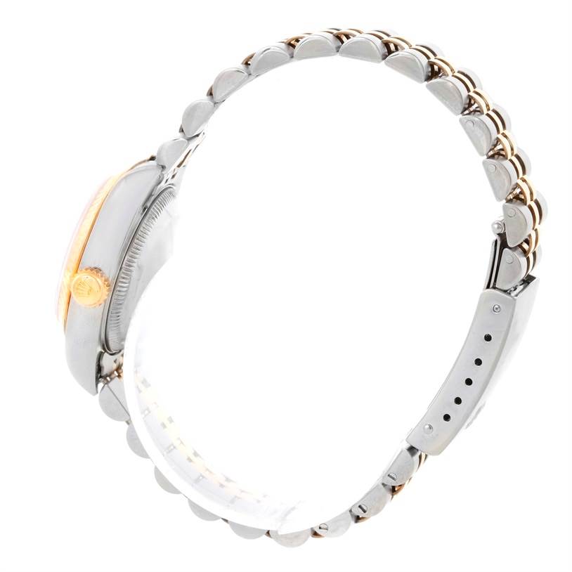 The image shows a side view of a Rolex Datejust 79163 Women's Steel and Gold (two tone) Pink Dial 79163 Women's Steel and Gold (two tone) Pink Dial watch, highlighting the crown and the metal bracelet.