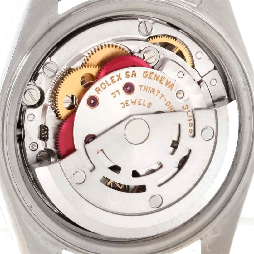 This image shows the intricate internal mechanism of the Rolex Datejust 79163 Women's Steel and Gold (two tone) Pink Dial 79163 Women's Steel and Gold (two tone) Pink Dial watch, highlighting gears and jewels.
