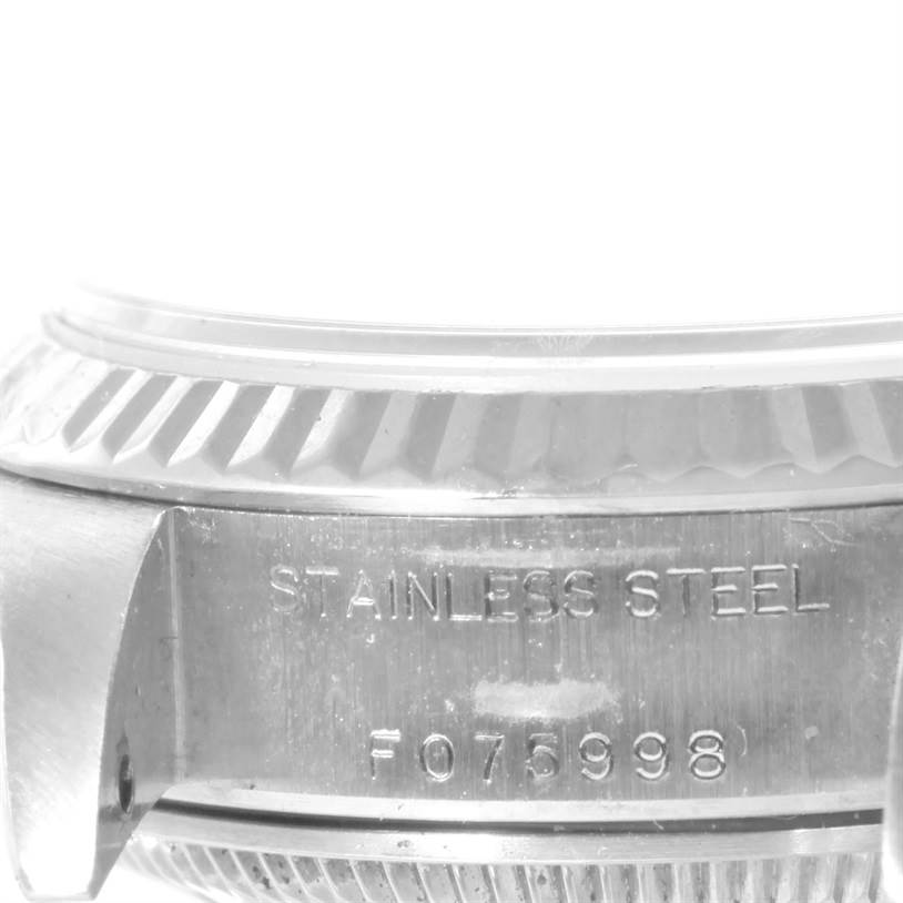 This is a close-up view showing part of the stainless steel case back and bezel of the Rolex Datejust 79174 Women's Stainless Steel White Dial 79174 Women's Stainless Steel White Dial watch.