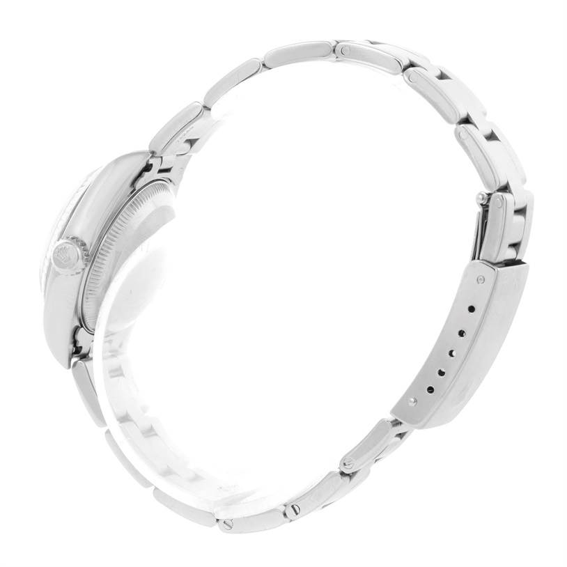 This image shows a side view of the Rolex Datejust 79174 Women's Stainless Steel White Dial 79174 Women's Stainless Steel White Dial watch, highlighting the case, crown, and partially open bracelet.