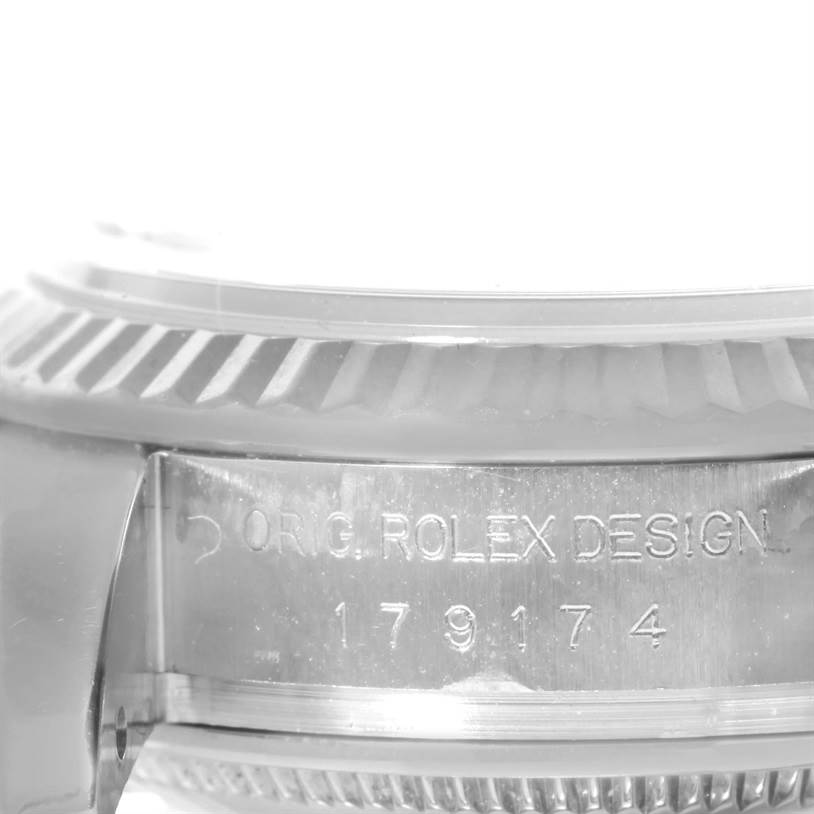 This image shows a close-up of the side view of a Rolex Datejust 179174 Women's Stainless Steel Silver Dial 179174 Women's Stainless Steel Silver Dial model, highlighting the “Orig. Rolex Design” engraving and serial number.