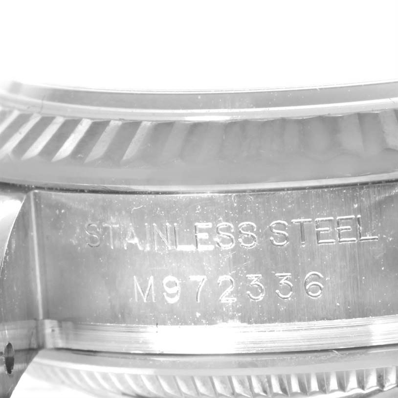 The image shows a close-up of the case and bezel of a Rolex Datejust 179174 Women's Stainless Steel Silver Dial 179174 Women's Stainless Steel Silver Dial watch, highlighting its stainless steel material and serial number.