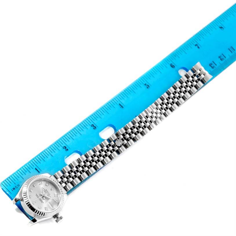 The Rolex Datejust 179174 Women's Stainless Steel Silver Dial 179174 Women's Stainless Steel Silver Dial watch is shown from a top view, with a blue ruler displaying the length of the bracelet.