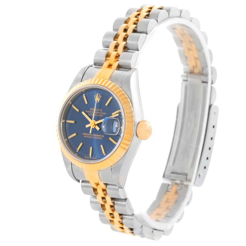 The image shows a left-side angled view of a Rolex Datejust 79173 Women's Stainless Steel Blue Dial 79173 Women's Stainless Steel Blue Dial watch featuring a two-tone steel and gold bracelet, blue dial, and fluted bezel.