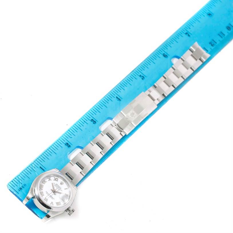 The image shows a Rolex Datejust 179160 Women's Stainless Steel White Dial 179160 Women's Stainless Steel White Dial watch fully extended, placed alongside a blue ruler for measurement.