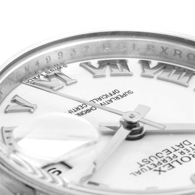 This close-up image of the Rolex Datejust 179160 Women's Stainless Steel White Dial 179160 Women's Stainless Steel White Dial watch shows part of the dial, hands, Roman numerals, and the rehaut with engravings.