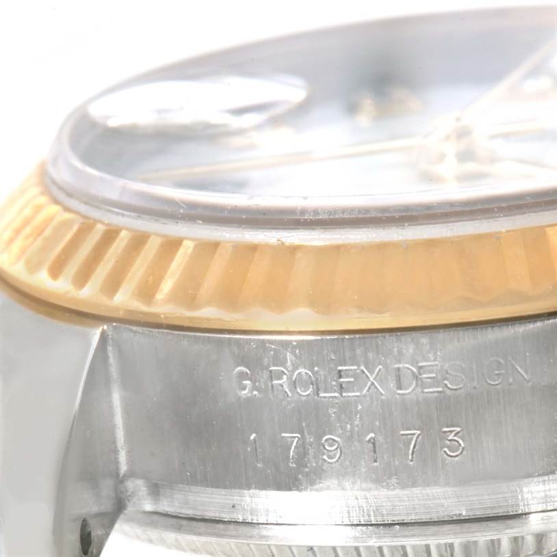 This image shows a close-up angle of the bezel and case, featuring the model number and "Rolex Design" inscription on a Rolex Datejust 179173 Women's Steel and Gold (two tone) White Dial 179173 Women's Steel and Gold (two tone) White Dial watch.