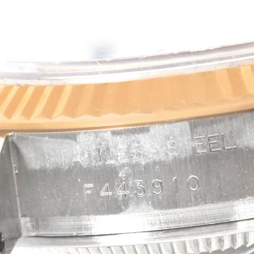 Close-up angle showing the case and part of the fluted bezel of a Rolex Datejust 179173 Women's Steel and Gold (two tone) White Dial 179173 Women's Steel and Gold (two tone) White Dial watch, with stainless steel engraved.