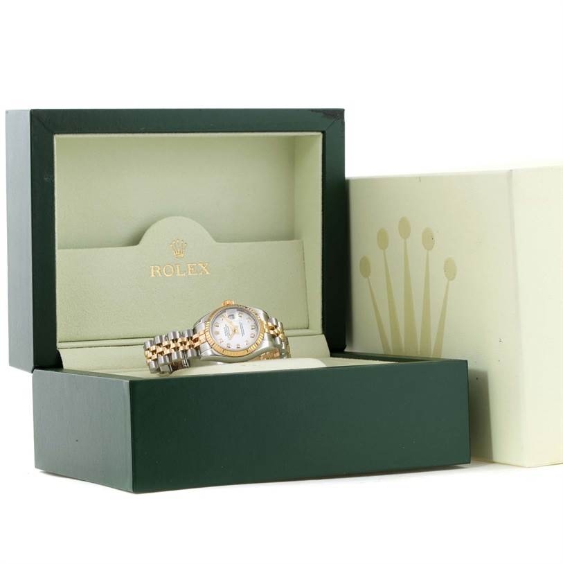 The image shows a Rolex Datejust 179173 Women's Steel and Gold (two tone) White Dial 179173 Women's Steel and Gold (two tone) White Dial watch from a front angle inside its green and gold presentation box.