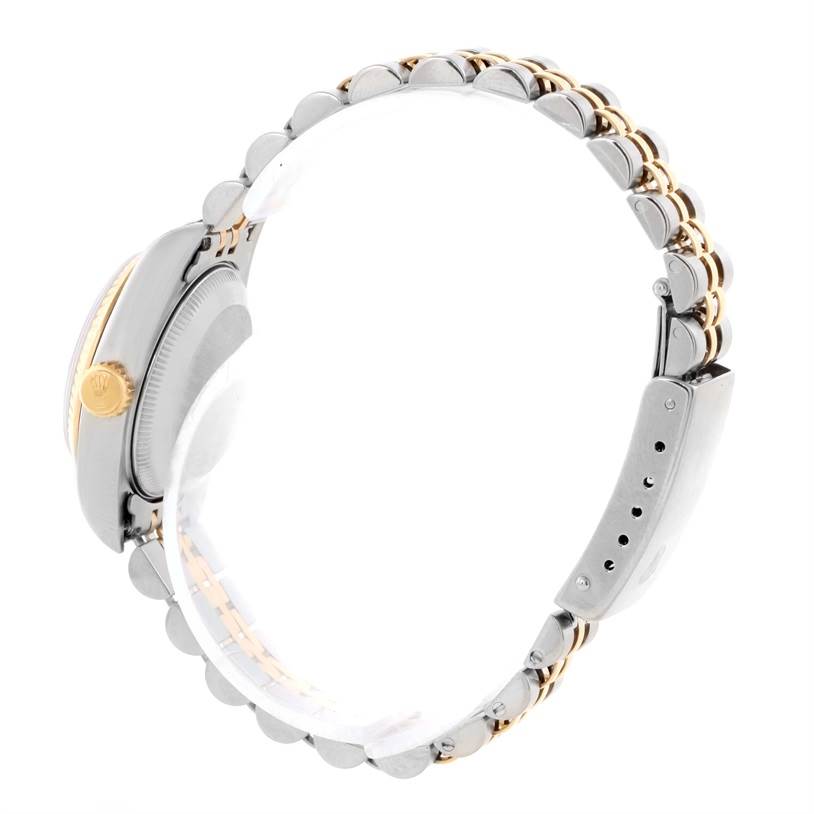 The image shows a side view of a Rolex Datejust 69173 Women's Stainless Steel Champagne Dial 69173 Women's Stainless Steel Champagne Dial watch, highlighting the crown, bezel, and two-tone bracelet.