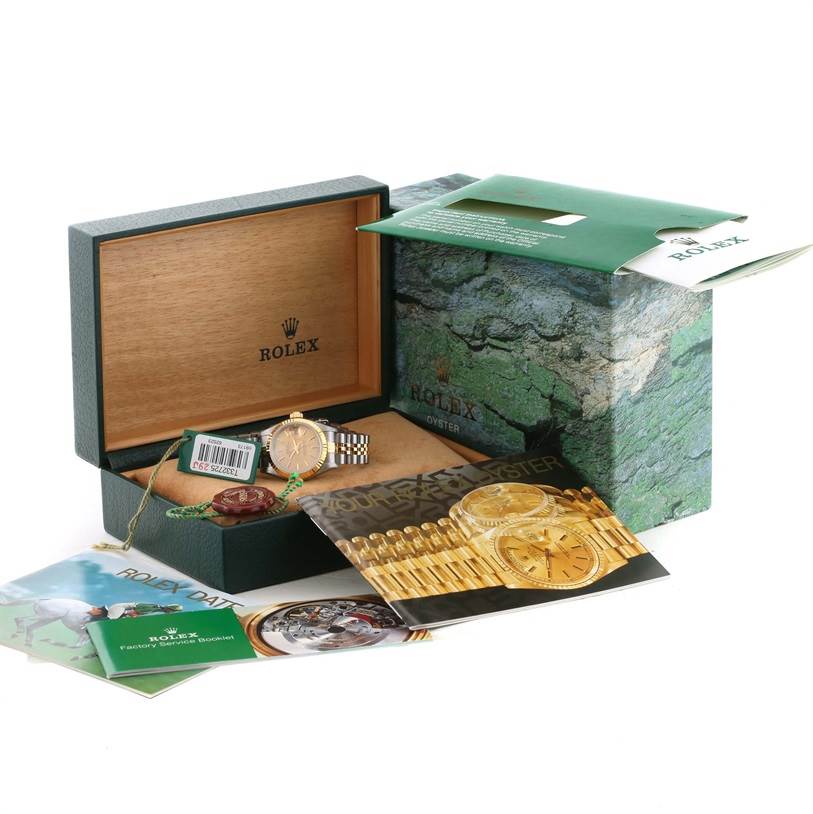 The image shows a Rolex Datejust 69173 Women's Stainless Steel Champagne Dial 69173 Women's Stainless Steel Champagne Dial watch in an open green box, accompanied by booklets and accessories, viewed from the front.