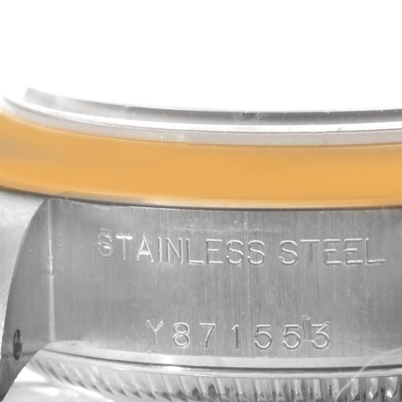 The image shows a close-up of the stainless steel case side of a Rolex Datejust 79163 Women
s Steel and Gold (two tone) Blue Dial 79163 Women
s Steel and Gold (two tone) Blue Dial with part of the serial number and bezel visible.