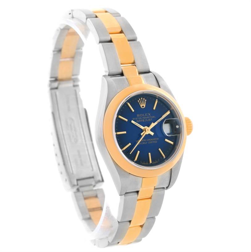 The image shows a Rolex Datejust 79163 Women
s Steel and Gold (two tone) Blue Dial 79163 Women
s Steel and Gold (two tone) Blue Dial watch angled to display the dial, crown, and two-tone bracelet.