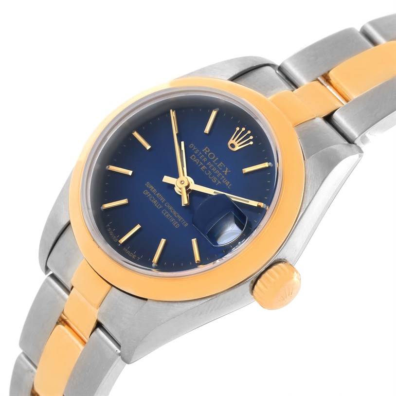 The image shows a Rolex Datejust 79163 Women
s Steel and Gold (two tone) Blue Dial 79163 Women
s Steel and Gold (two tone) Blue Dial model watch at an angle emphasizing the face, crown, and part of the two-tone bracelet.