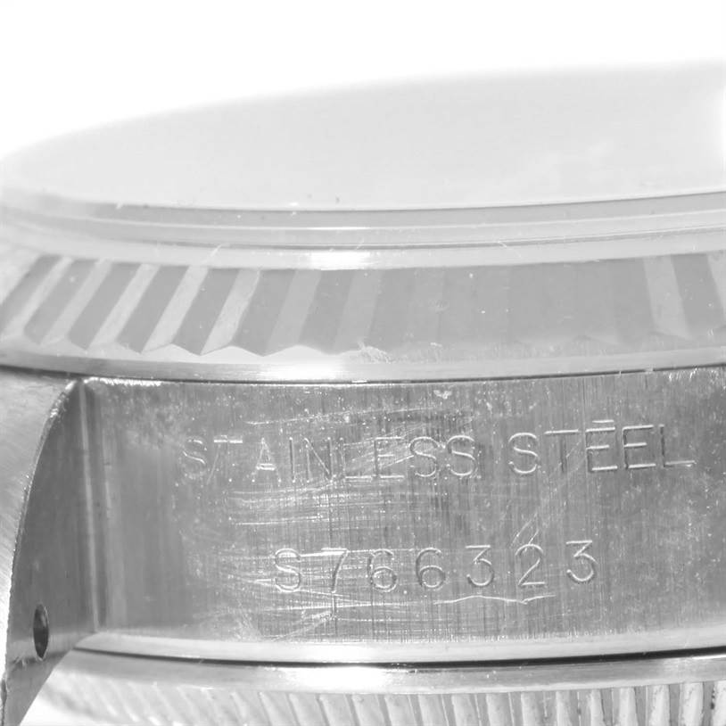 This image shows a close-up of the side of a Rolex Datejust 69174 Women
s Stainless Steel Pink Dial 69174 Women
s Stainless Steel Pink Dial watch case, highlighting the fluted bezel and engraved model number.