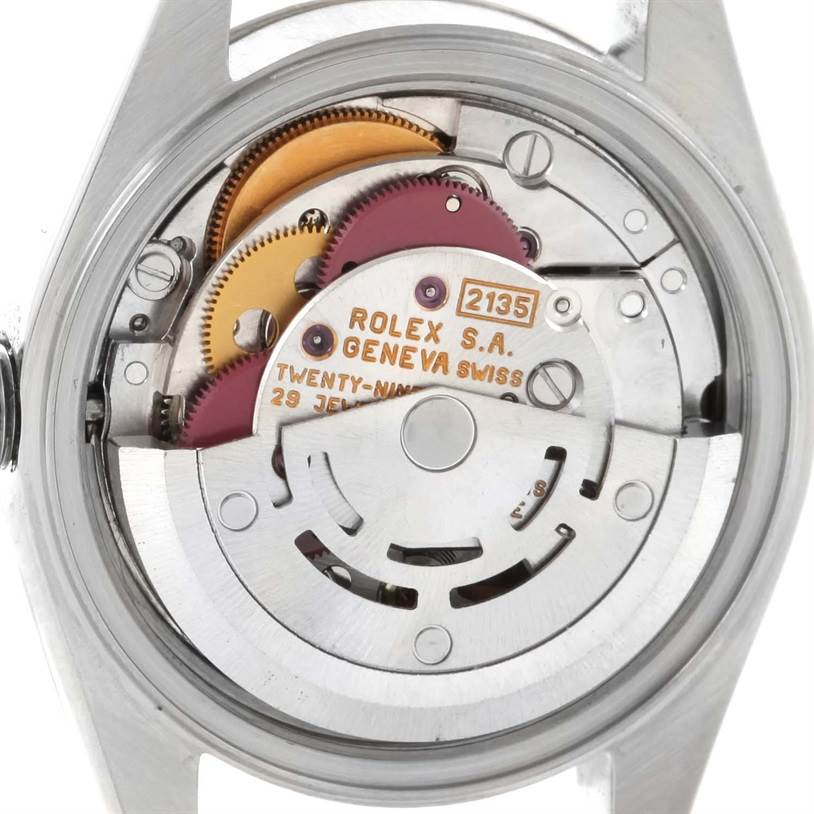 The image shows the movement mechanism and inner workings of a Rolex Datejust 69174 Women
s Stainless Steel Pink Dial 69174 Women
s Stainless Steel Pink Dial model from a rear angle.