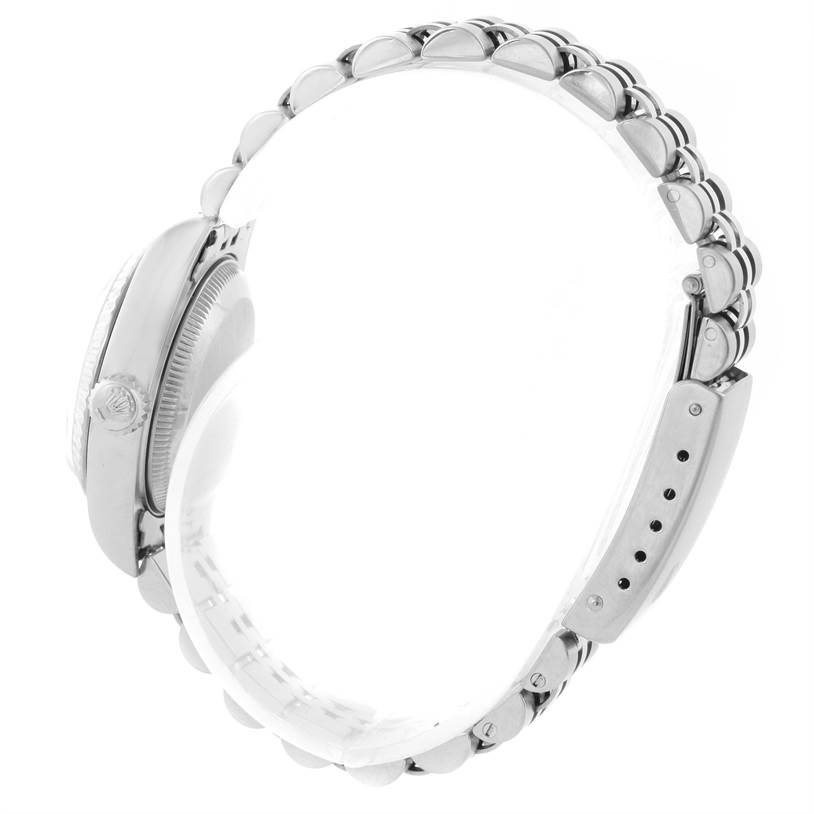 The image shows a Rolex Datejust 69174 Women
s Stainless Steel Pink Dial 69174 Women
s Stainless Steel Pink Dial watch from a side angle, highlighting the crown, case, and bracelet with the clasp.