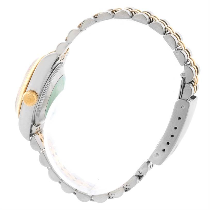 Side view of a Rolex Datejust 69173 Women's Stainless Steel Champagne Dial 69173 Women's Stainless Steel Champagne Dial watch showing the crown, case, and bracelet.