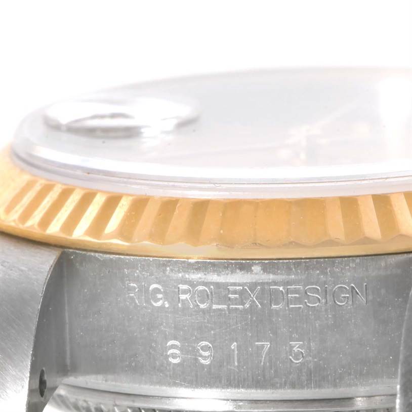 The image shows a close-up of the bezel, crystal, and part of the case side of a Rolex Datejust 69173 Women's Stainless Steel Champagne Dial 69173 Women's Stainless Steel Champagne Dial watch.