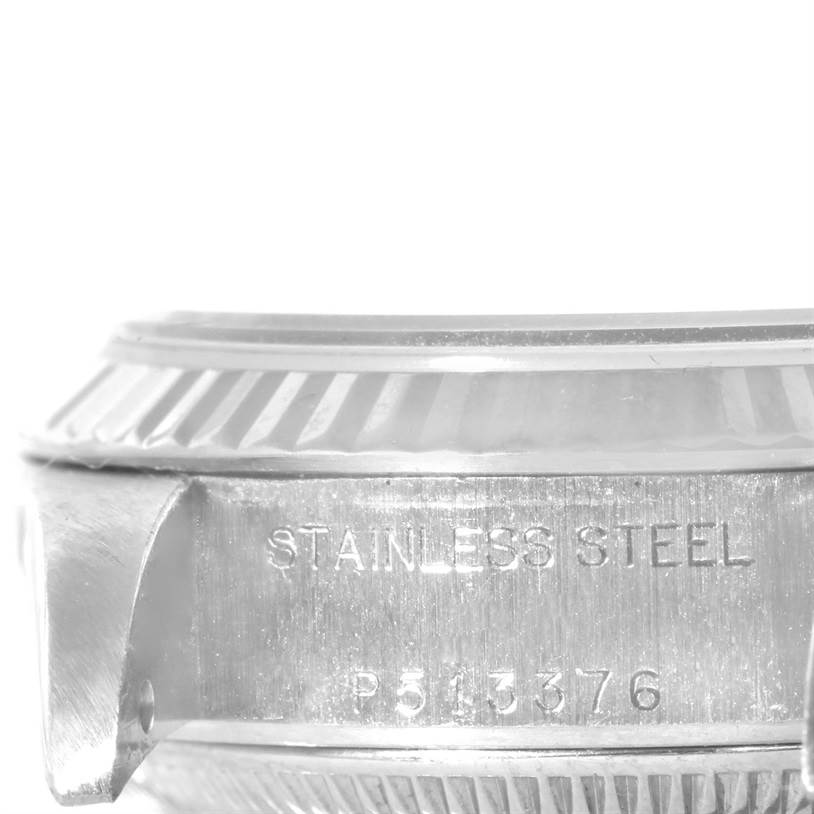 The image shows a close-up side view of the stainless steel case and bezel of a Rolex Datejust 79174 Women
s Stainless Steel Mother of Pearl Dial 79174 Women
s Stainless Steel Mother of Pearl Dial watch, including part of the serial number.