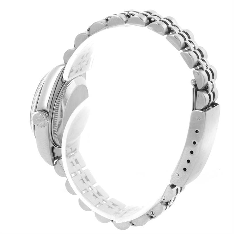 This side view of the Rolex Datejust 69174 Women
s Stainless Steel Black Dial 69174 Women
s Stainless Steel Black Dial watch shows its clasp, links, and partially the crown.