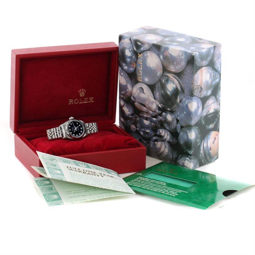 The image shows a Rolex Datejust 69174 Women
s Stainless Steel Black Dial 69174 Women
s Stainless Steel Black Dial watch in a red box with accompanying warranty card and outer packaging.